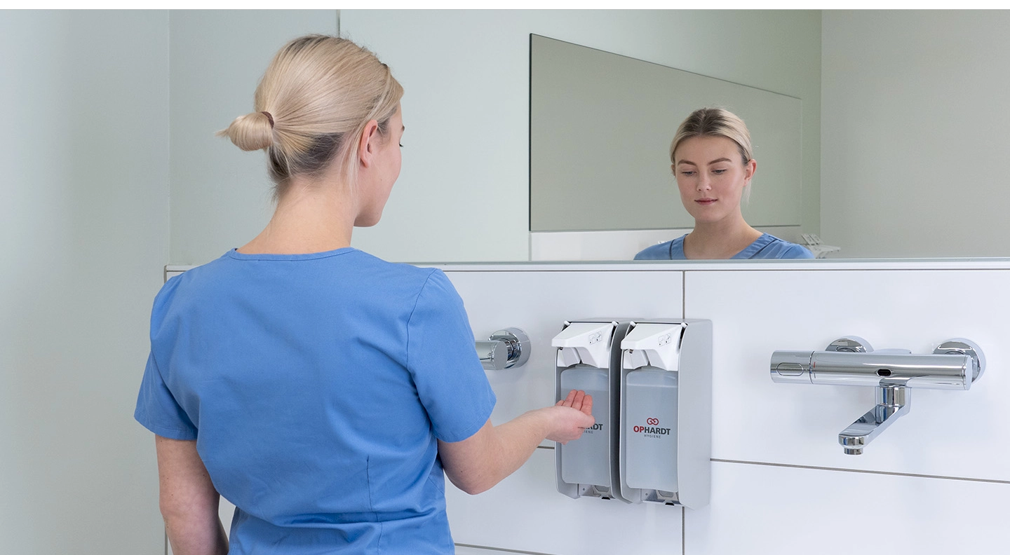 Nurse using touchless dispenser.
