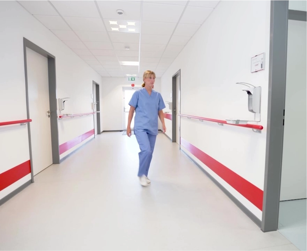Nurse walking to ingo-man dispenser